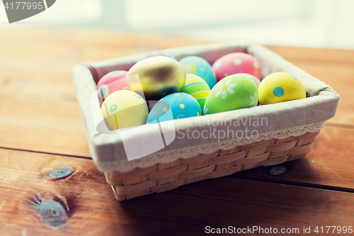 Image of close up of colored easter eggs in basket