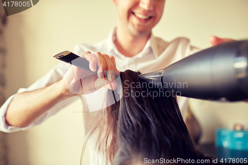 Image of  close up of stylist making hairdo at salon