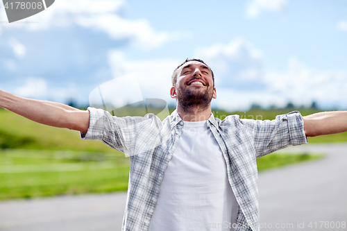Image of happy smiling man outdoors at summer
