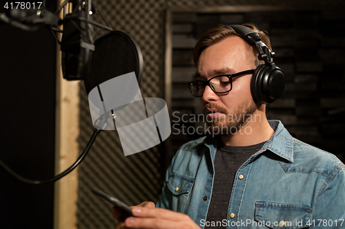 Image of man with headphones at music recording studio