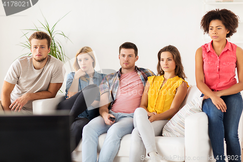 Image of friends watching tv at home