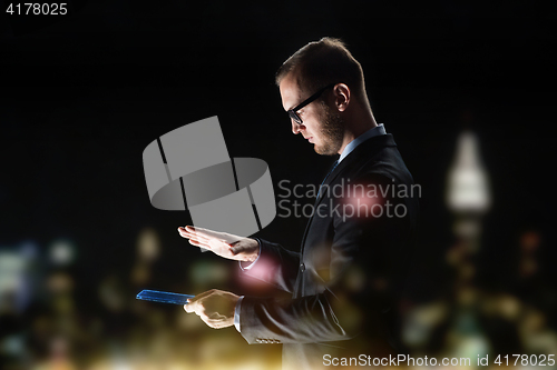 Image of close up of businessman with transparent tablet pc