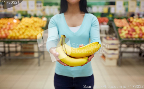Image of woman with bananas at grocery store