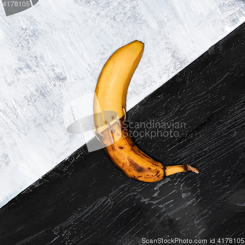 Image of Single banana against blue background