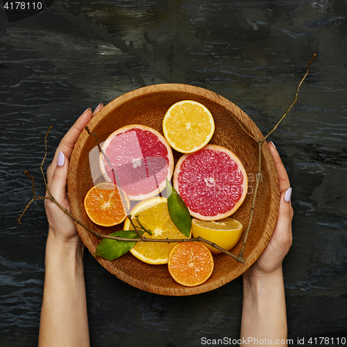 Image of Grapefruit citrus fruit halves on wooden plate