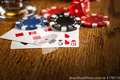 Image of Cigar, chips for gamblings, drink and playing cards