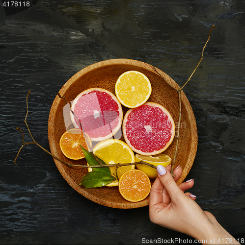 Image of Grapefruit citrus fruit halves on wooden plate