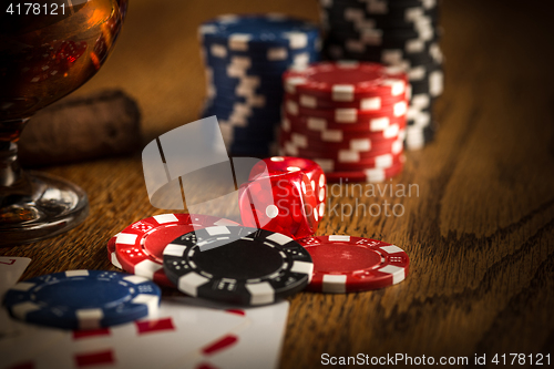 Image of Cigar, chips for gamblings, drink and playing cards