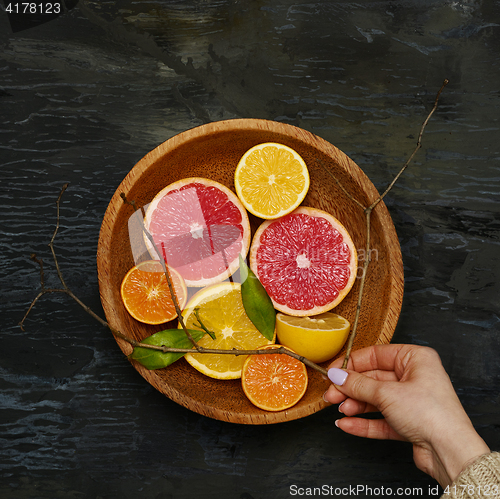 Image of Grapefruit citrus fruit halves on wooden plate