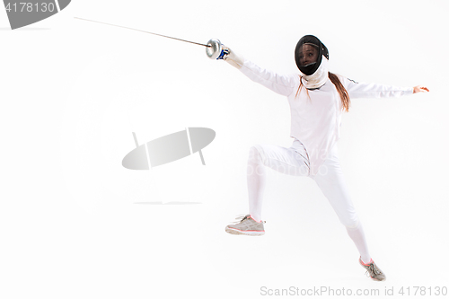 Image of Man wearing fencing suit practicing with sword against gray