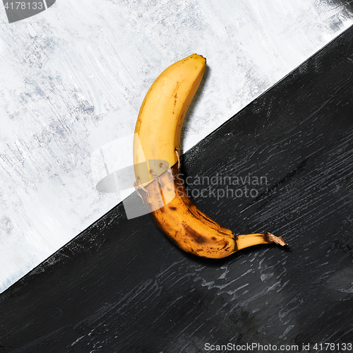 Image of Single banana against blue background