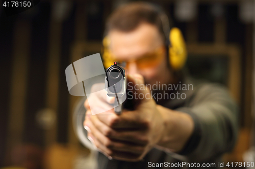 Image of Gun. Sport shooting range. The man at the shooting range.