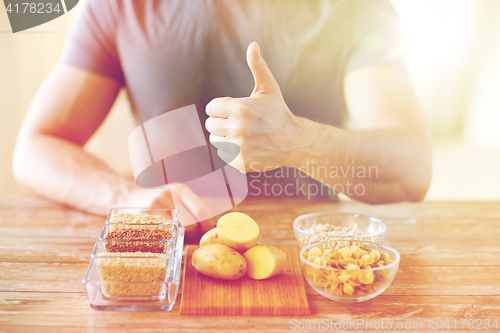 Image of close up of male hands with carbohydrate food