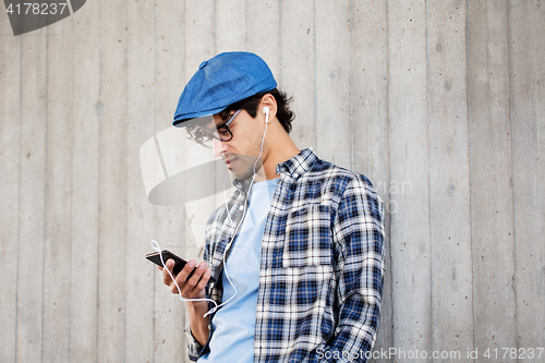 Image of man with earphones and smartphone listening music