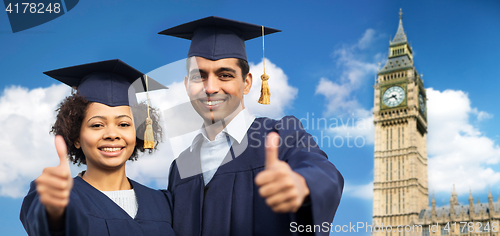 Image of happy students or bachelors showing thumbs up