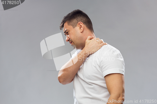 Image of unhappy man suffering from neck pain