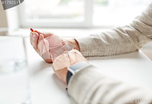 Image of close up of old man hands with pill