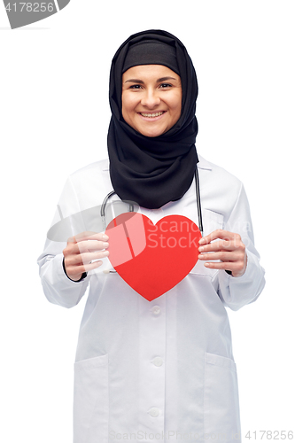 Image of muslim female doctor in hijab holding red heart