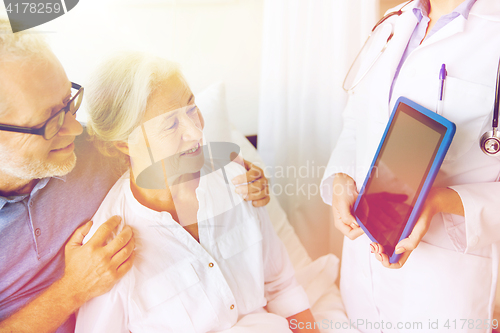 Image of senior woman and doctor with tablet pc at hospital