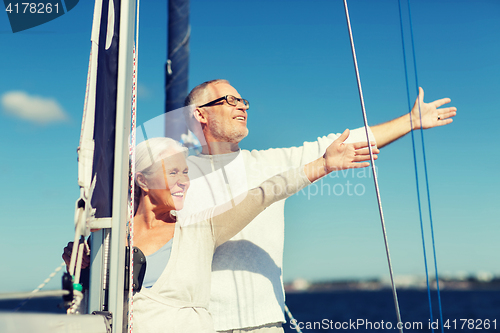 Image of senior couple hugging on sail boat or yacht in sea