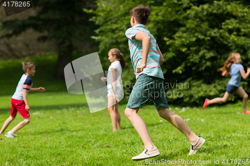 Image of group of happy kids or friends playing outdoors