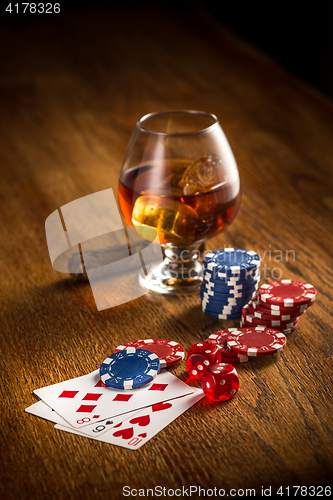 Image of Cigar, chips for gamblings, drink and playing cards