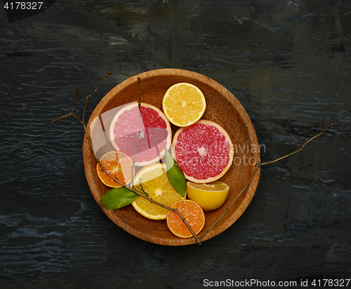 Image of Grapefruit citrus fruit halves on wooden plate