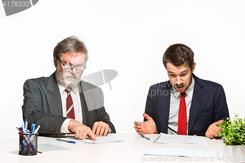 Image of The two colleagues working together at office on white background.