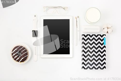 Image of Top view of white office table with laptop