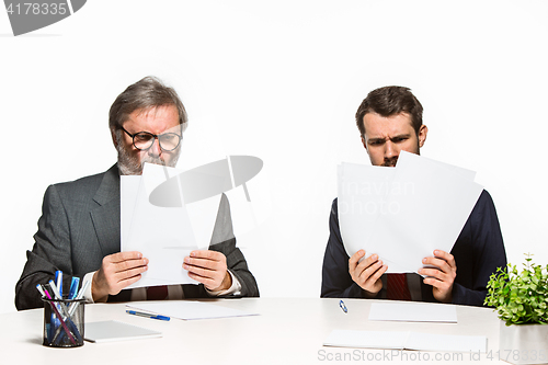 Image of The two colleagues working together at office on white background.