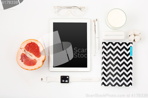 Image of Top view of white office table with laptop