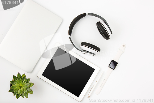 Image of Top view of white office female workspace with laptop