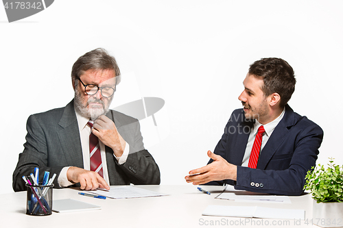 Image of The two colleagues working together at office on white background.