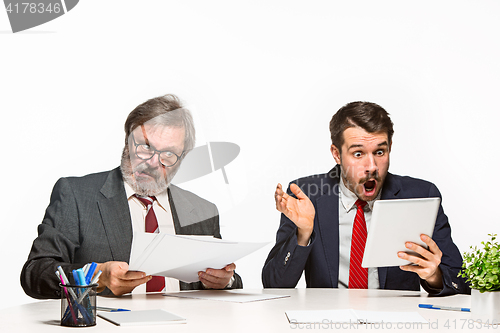 Image of The two colleagues working together at office on white background.