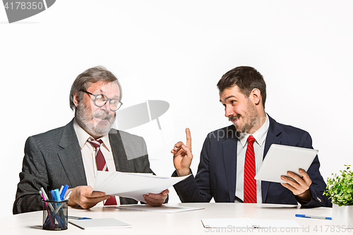 Image of The two colleagues working together at office on white background.