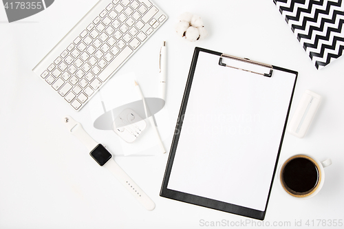 Image of Top view of white office table with notebook