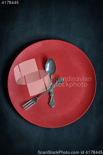 Image of Clock with red plate, spoon and fork