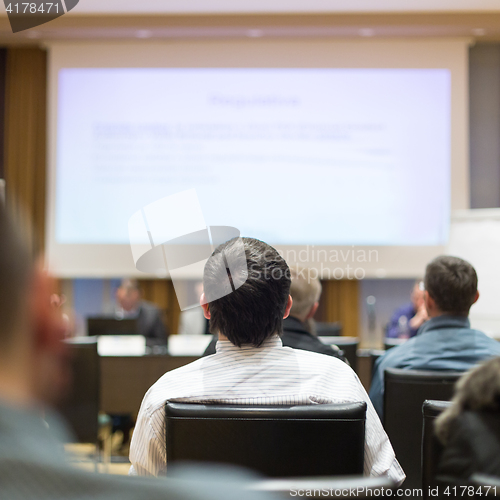 Image of Audience in lecture hall participating at business conference.