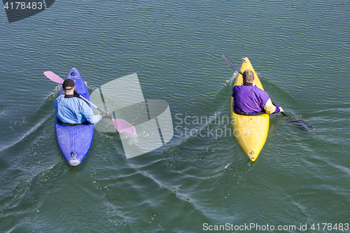Image of Two rowers with canoe recreate in a lake