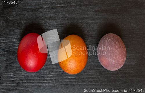 Image of Easter eggs on wooden background.