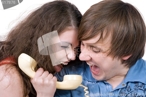 Image of The young couple with old phone. Funny picture. Isolated 2