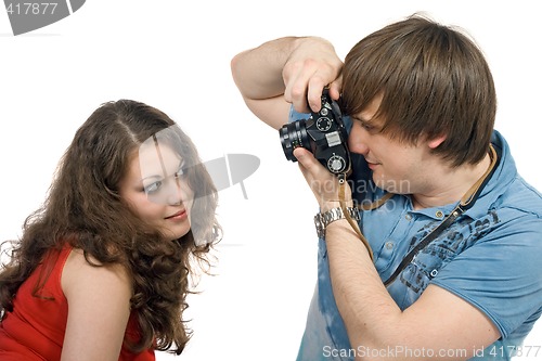 Image of Photographer taking pictures of the young woman. isolated