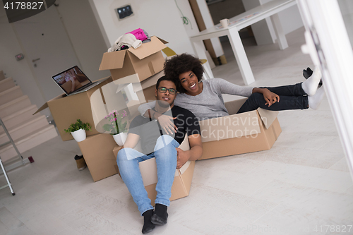 Image of African American couple  playing with packing material