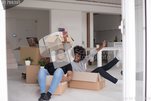 Image of African American couple  playing with packing material