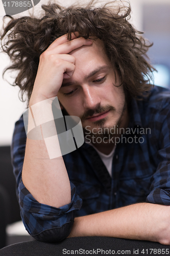 Image of A student sits alone  in a classroom