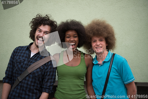 Image of multiethnic group of happy three friends