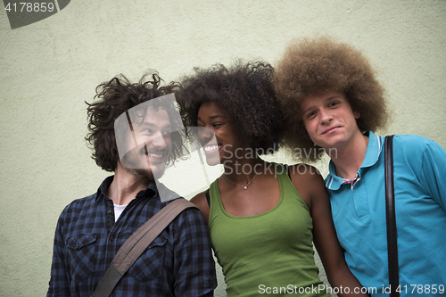 Image of multiethnic group of happy three friends