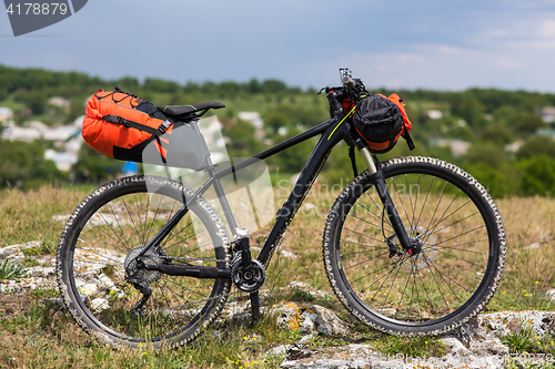 Image of Bicycle with orange bags for travel