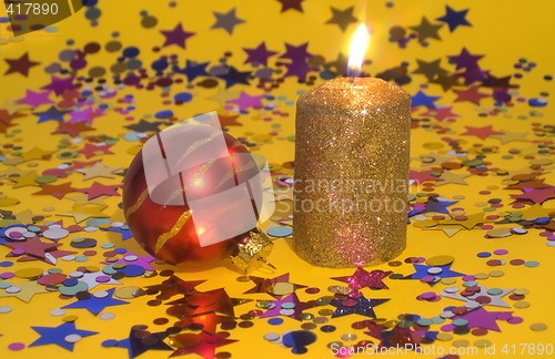 Image of Gold candle and red glass ball