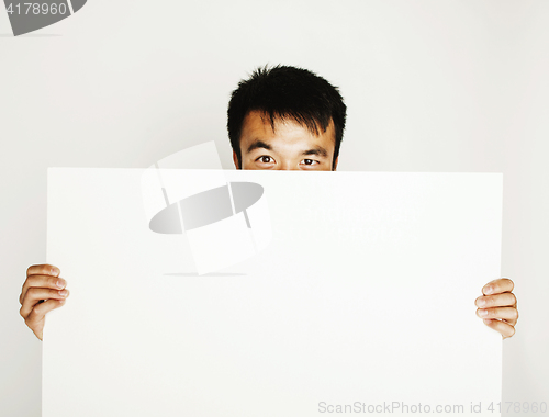 Image of pretty cool asian man holding empty white plate smiling